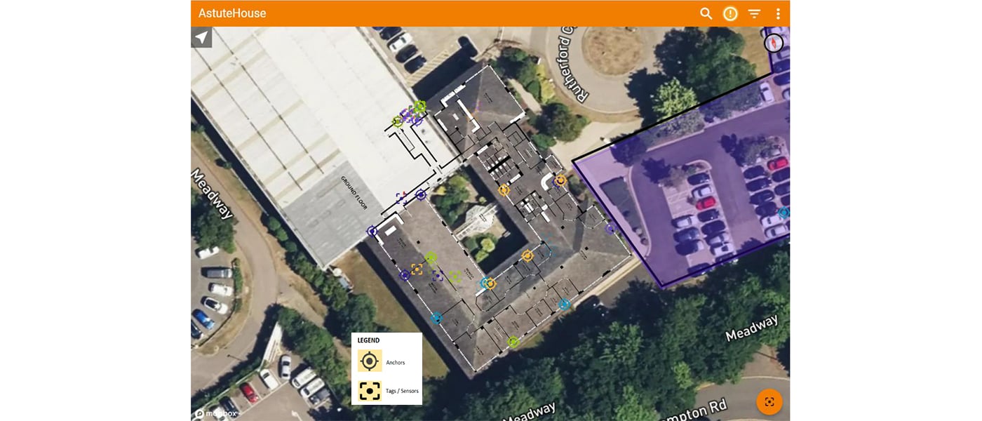 Satellite map view of a building complex showing LoRa asset tracking system deployment, with anchor nodes (circular target symbols) and tags/sensors (square symbols) positioned throughout the buildings and grounds. The map displays various colored markers distributed across the campus structures and parking areas, with a legend identifying anchors and tags/sensors. Roads including Meadway and Crompton Rd are visible around the perimeter of the tracked area
