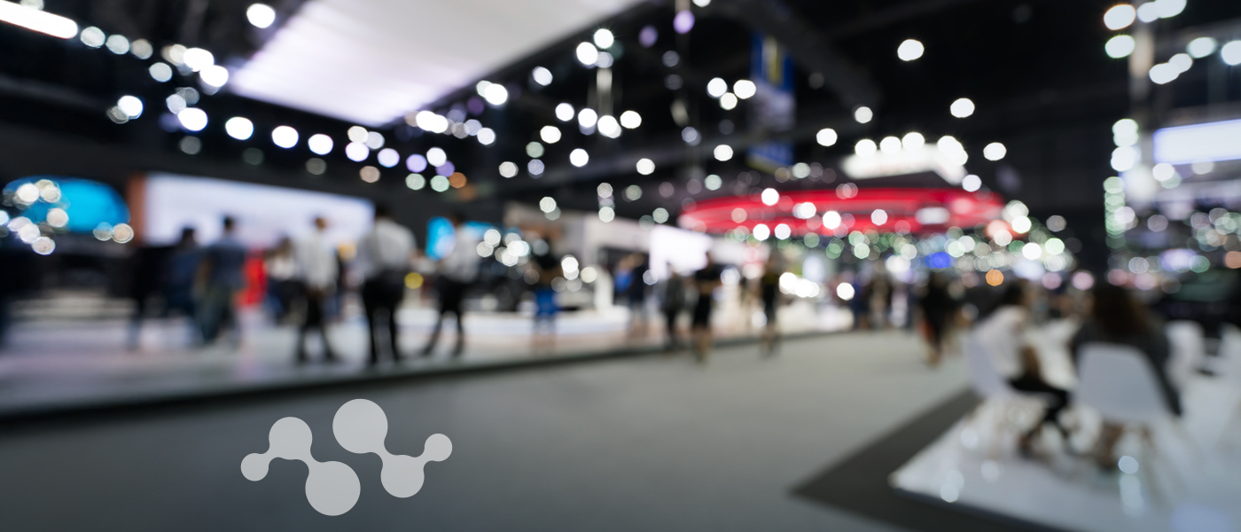 OTE 2025 Shanghai conference venue with blurred exhibition booths and IoT network graphic